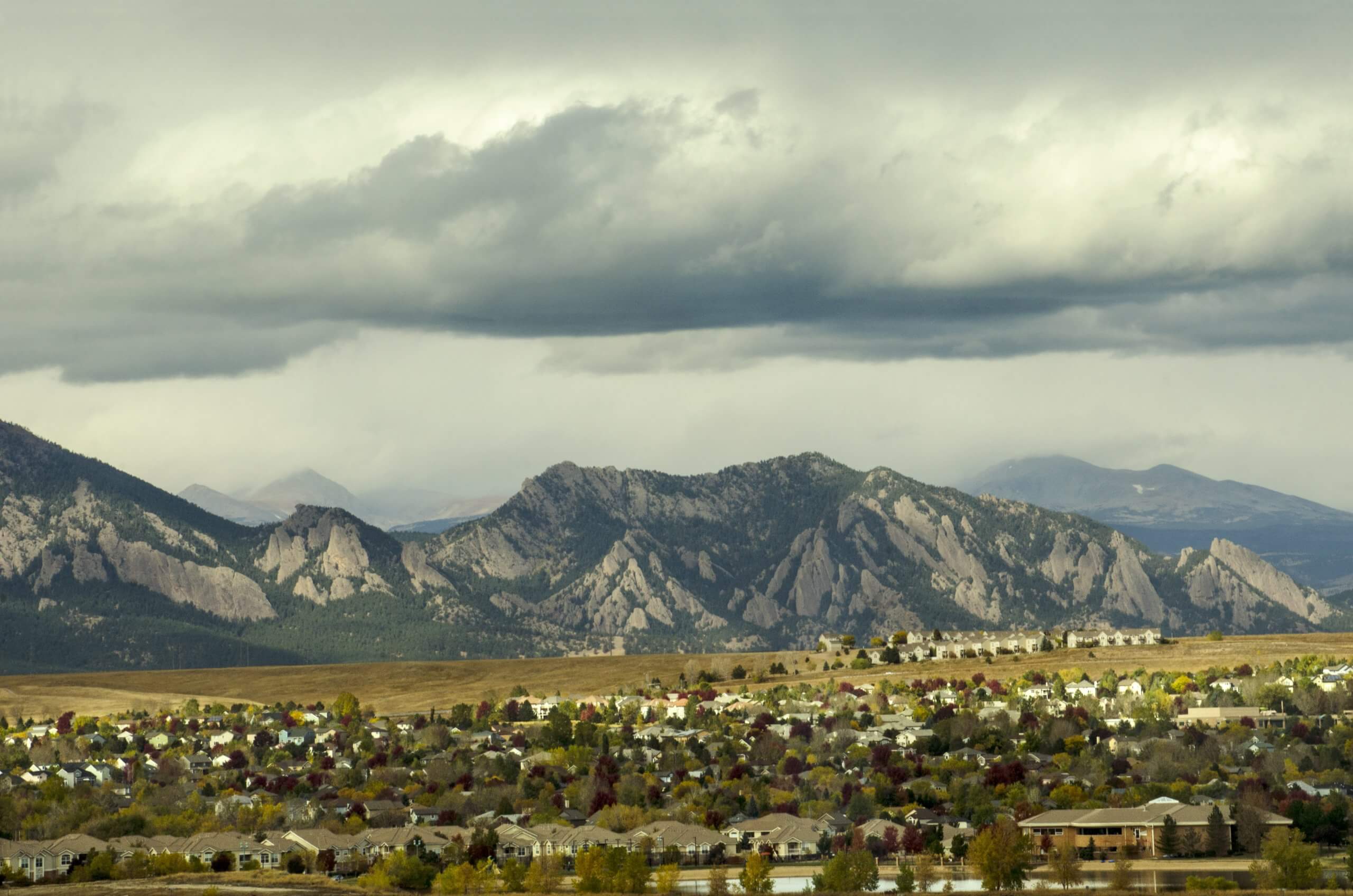 Urban sprawl from the developments in Broomfield, Colorado apprach the majestic range of the Flatiron Mountains. Carpenters work on a new sledding attraction at the top of Vail Mountain which overlooks the Colorado Rockies and Vail Pass. The Flatirons are rock formations in the western United States, near Boulder, Colorado, consisting of flatirons. There are five large, numbered Flatirons ranging from north to south along the east slope of Green Mountain, and the term "The Flatirons" sometimes refers to these five alone. Numerous additional named Flatirons are on the southern part of Green Mountain, Bear Peak, and among the surrounding foothills. Taken at sunrise from a height of over 100 feet in Broomfield, Colorado.